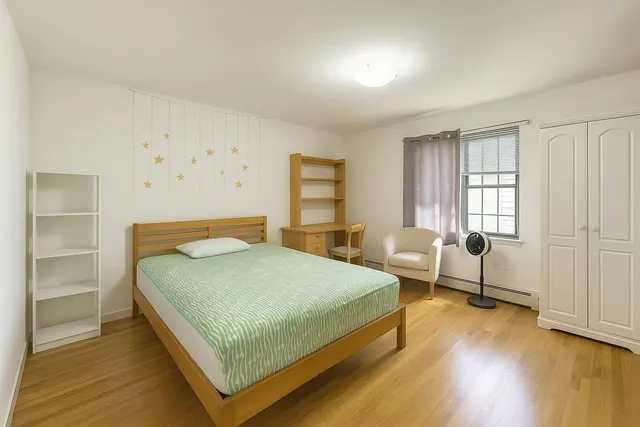 a bedroom with a bed and windows