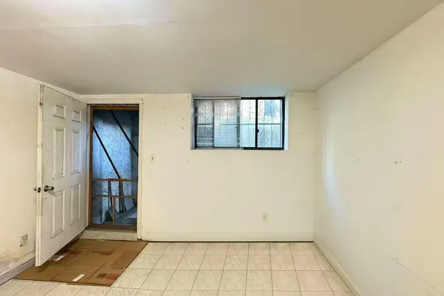 a view of a storage and utility room with racks on the wall