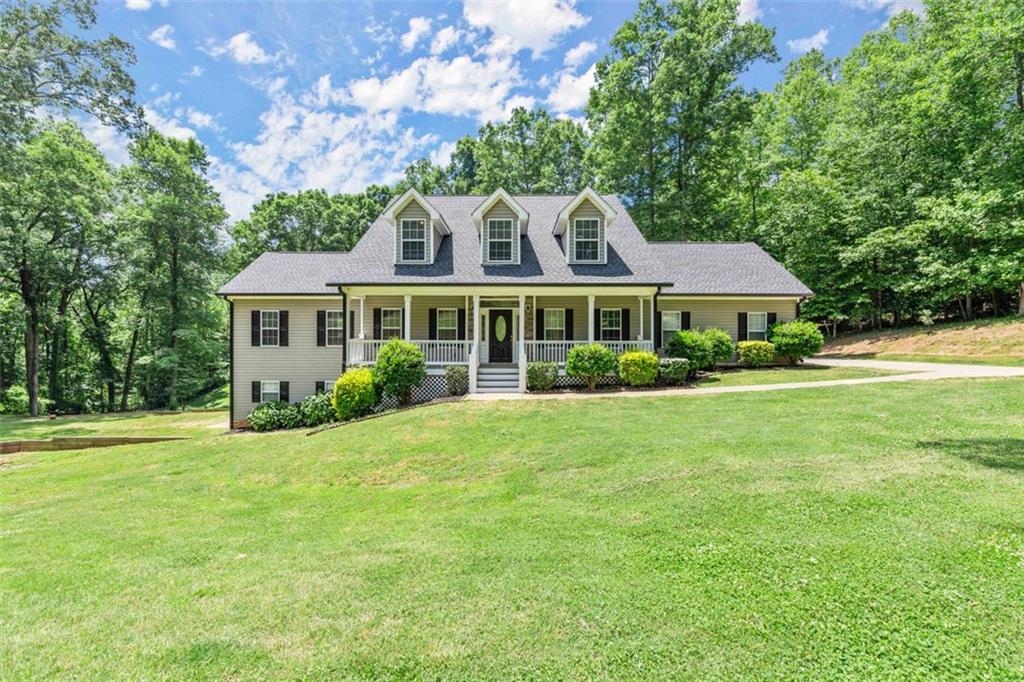 2245 Upper Bethany Road Ball Ground, GA 30107 - Photo 1 of 1 a front view of a house with a garden