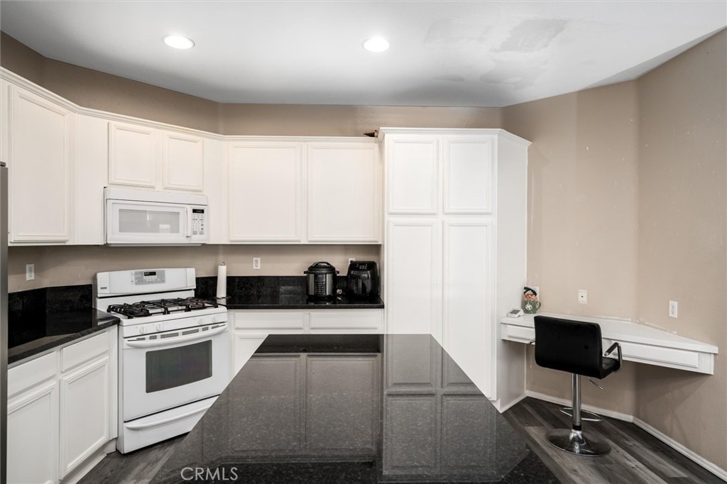 37867 Shady Maple Road Murrieta, CA 92563 - Photo 11 of 68 a kitchen with cabinets and appliances