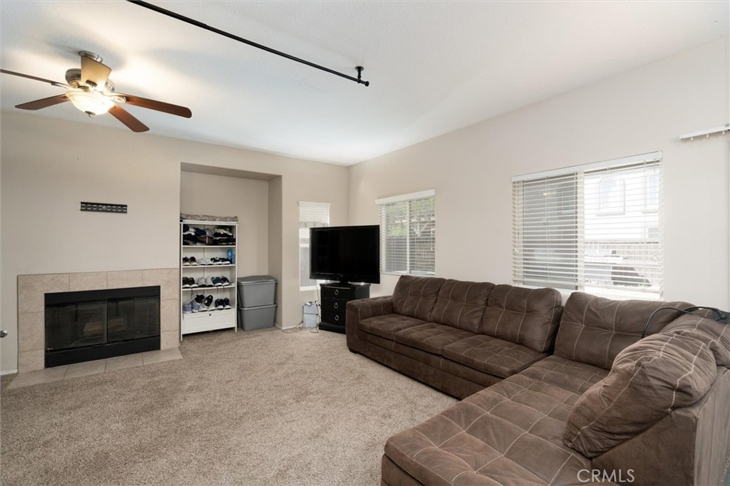 37867 Shady Maple Road Murrieta, CA 92563 - Photo 13 of 68 a living room with furniture a fireplace and a flat screen tv