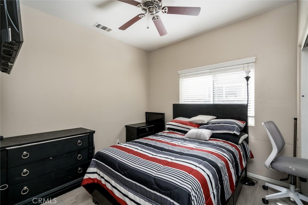 37867 Shady Maple Road Murrieta, CA 92563 - Photo 15 of 68 a bedroom with a bed and a chandelier