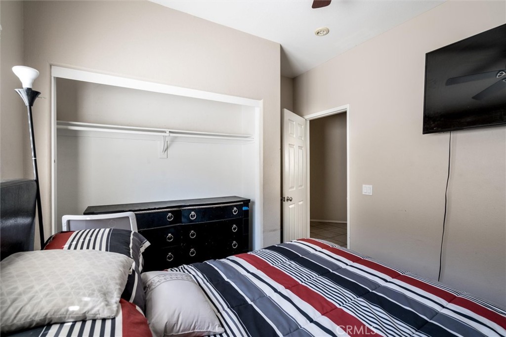 37867 Shady Maple Road Murrieta, CA 92563 - Photo 16 of 68 a bedroom with a bed and a flat screen tv