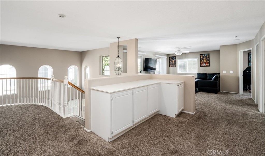 37867 Shady Maple Road Murrieta, CA 92563 - Photo 21 of 68 a living room with furniture a flat screen tv and a refrigerator