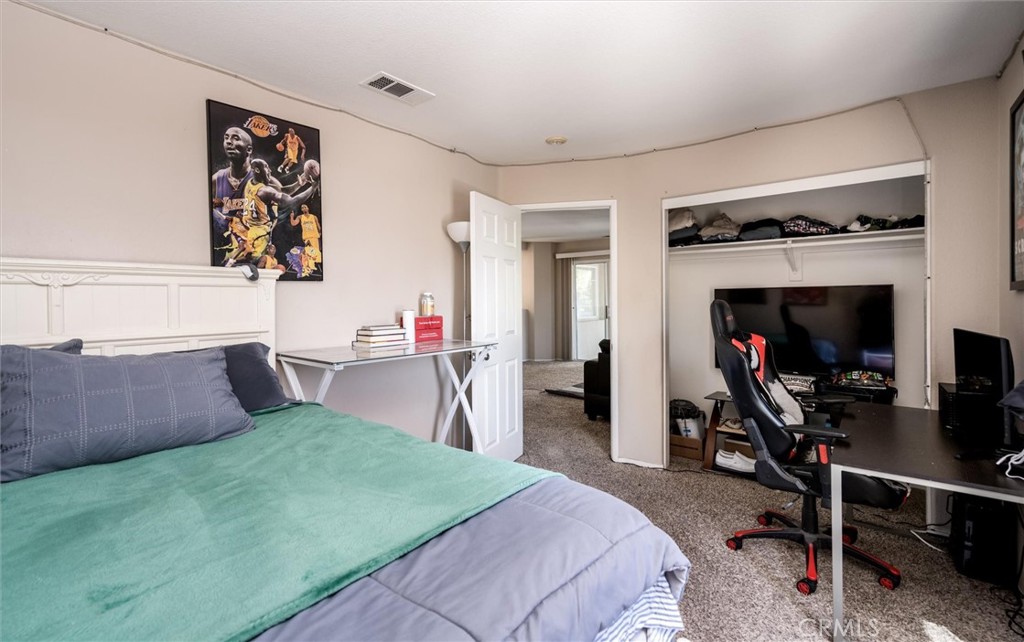 37867 Shady Maple Road Murrieta, CA 92563 - Photo 28 of 68 a bedroom with a bed and a flat screen tv