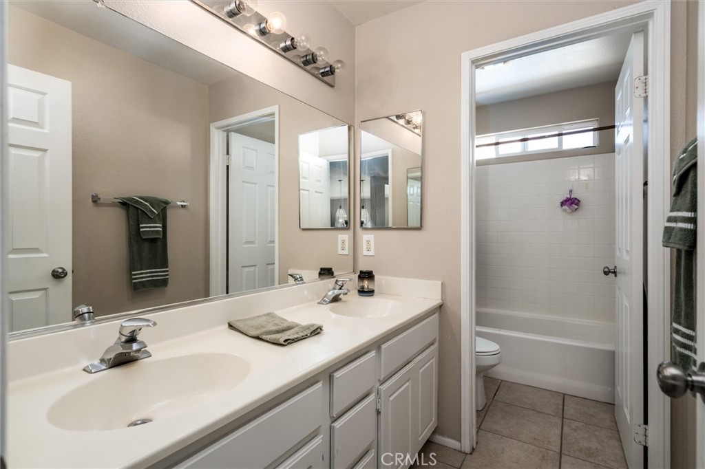 37867 Shady Maple Road Murrieta, CA 92563 - Photo 29 of 68 a bathroom with a sink a toilet and shower