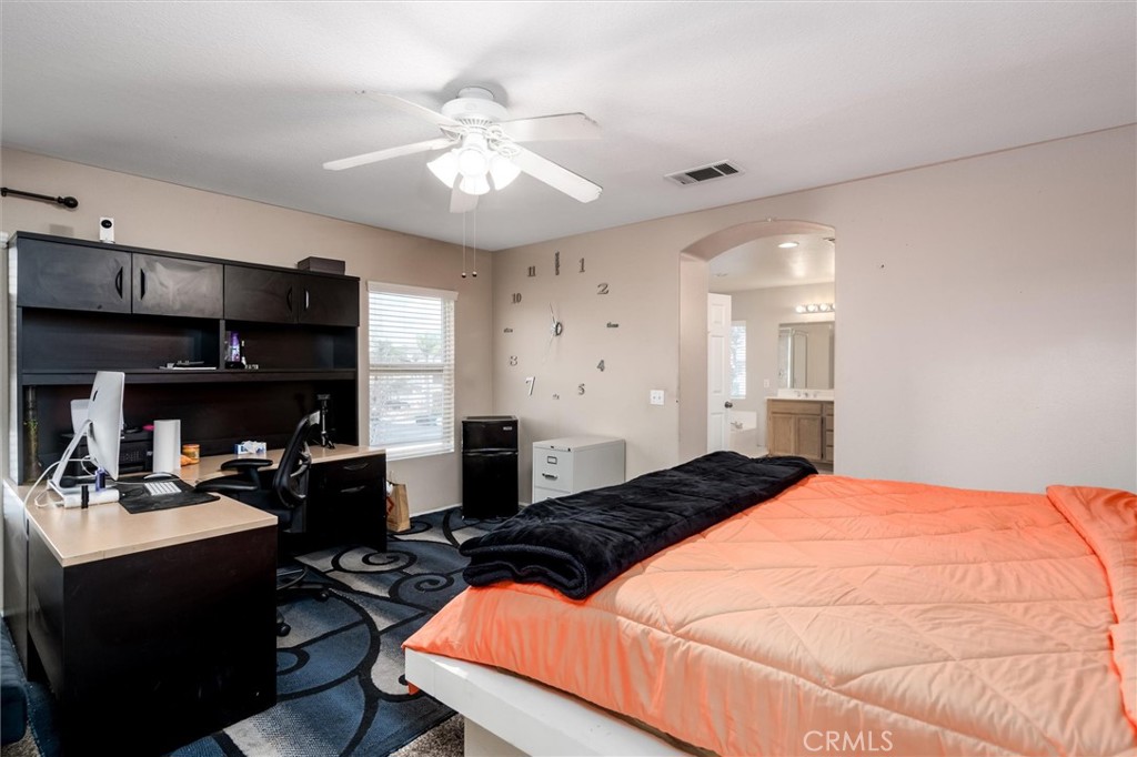 37867 Shady Maple Road Murrieta, CA 92563 - Photo 35 of 68 a bedroom with a bed and a chandelier