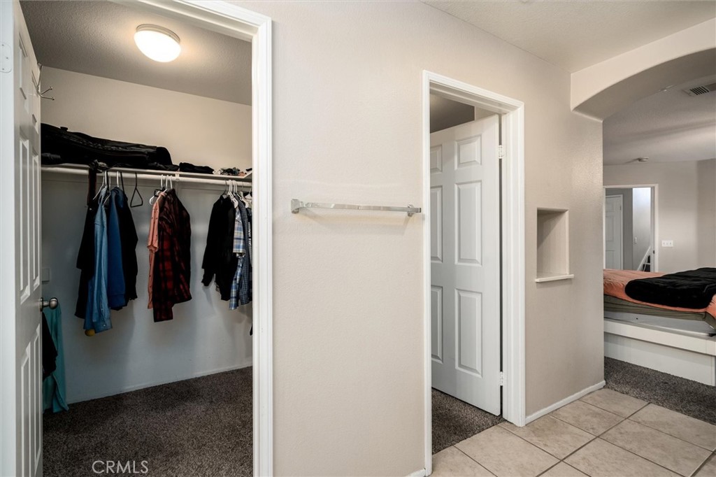 37867 Shady Maple Road Murrieta, CA 92563 - Photo 41 of 68 a view of walk in closet with clothes and shoes
