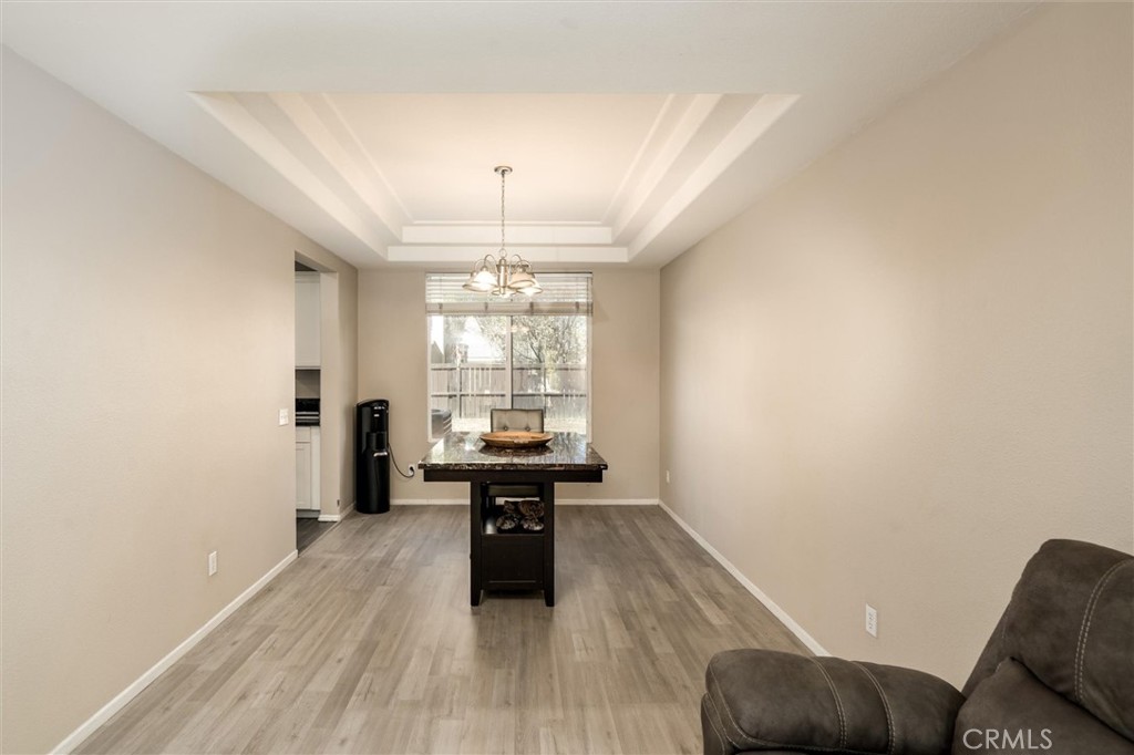 37867 Shady Maple Road Murrieta, CA 92563 - Photo 5 of 68 a view of a livingroom with furniture wooden floor and chandelier