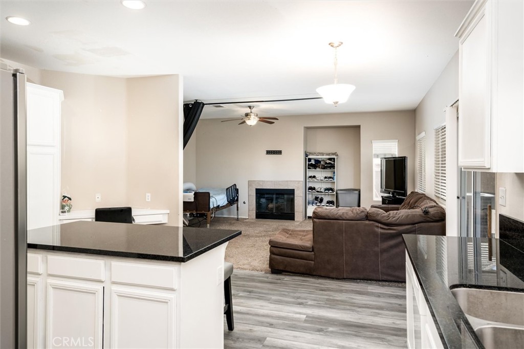 37867 Shady Maple Road Murrieta, CA 92563 - Photo 8 of 68 a living room with fireplace furniture and a wooden floor