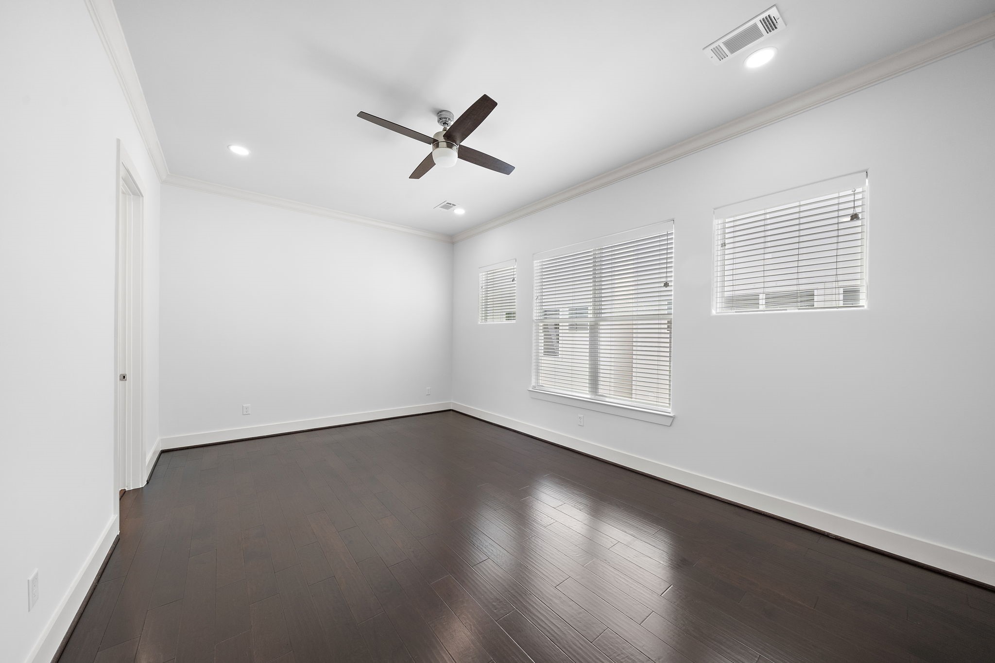 1015 West 24th Street, Unit B Houston, TX 77008 - Photo 16 of 19 a view of an empty room with a window and wooden floor