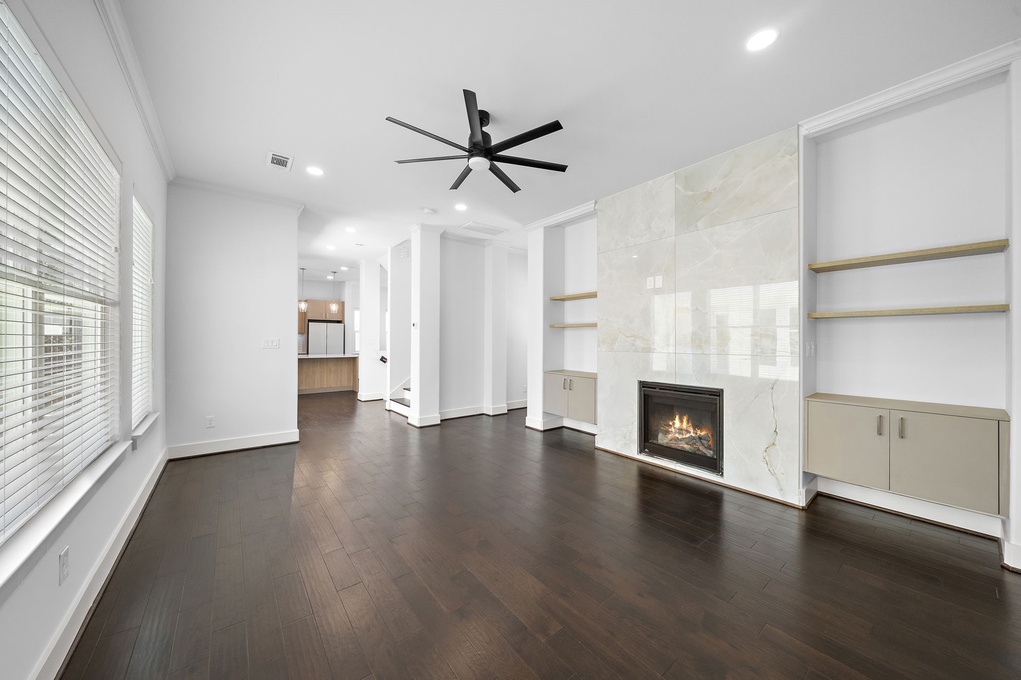 1015 West 24th Street, Unit B Houston, TX 77008 - Photo 10 of 19 an empty room with fireplace wooden floor and windows