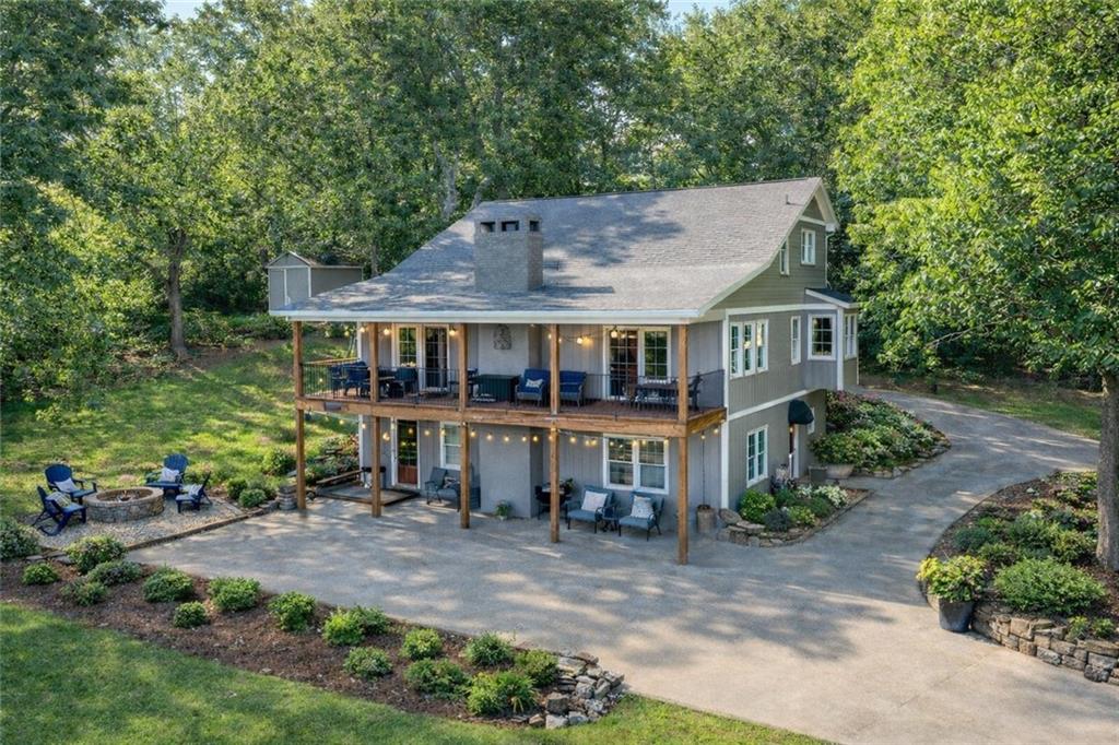 a view of house with a garden and swimming pool