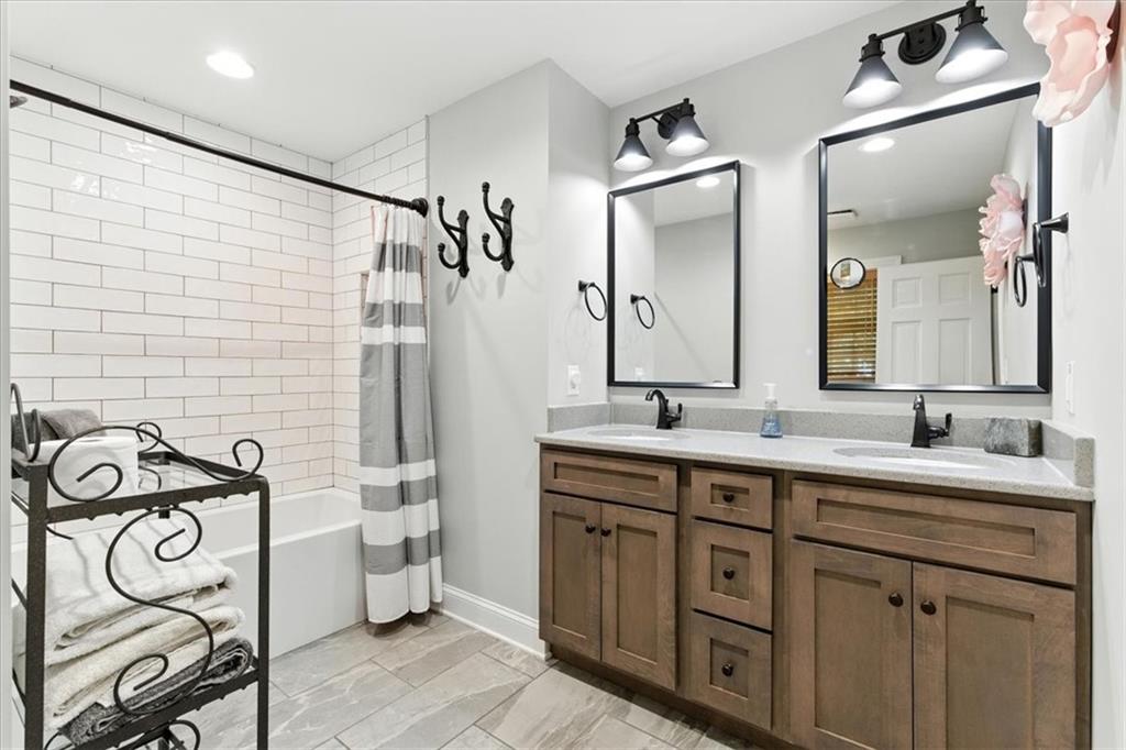 11 Brow Road Rome, GA 30165 - Photo 16 of 39 a bathroom with a double vanity sink mirror and a bathtub