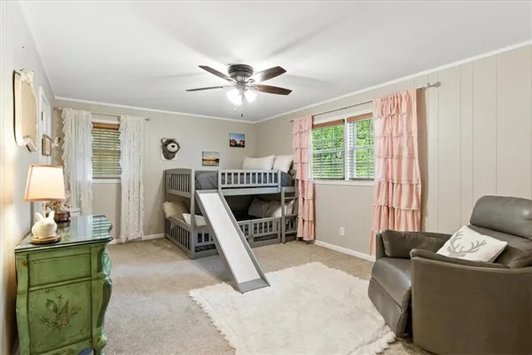 a living room with furniture a window and a fireplace