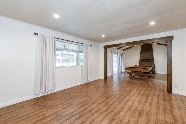 a hallway with a wooden floor and a window