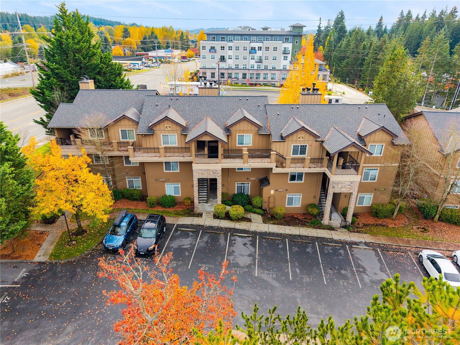 18930 Bothell Everett Highway, Unit G103 Bothell, WA 98012 - Photo 1 of 25 an aerial view of a house with swimming pool lawn chairs and a yard