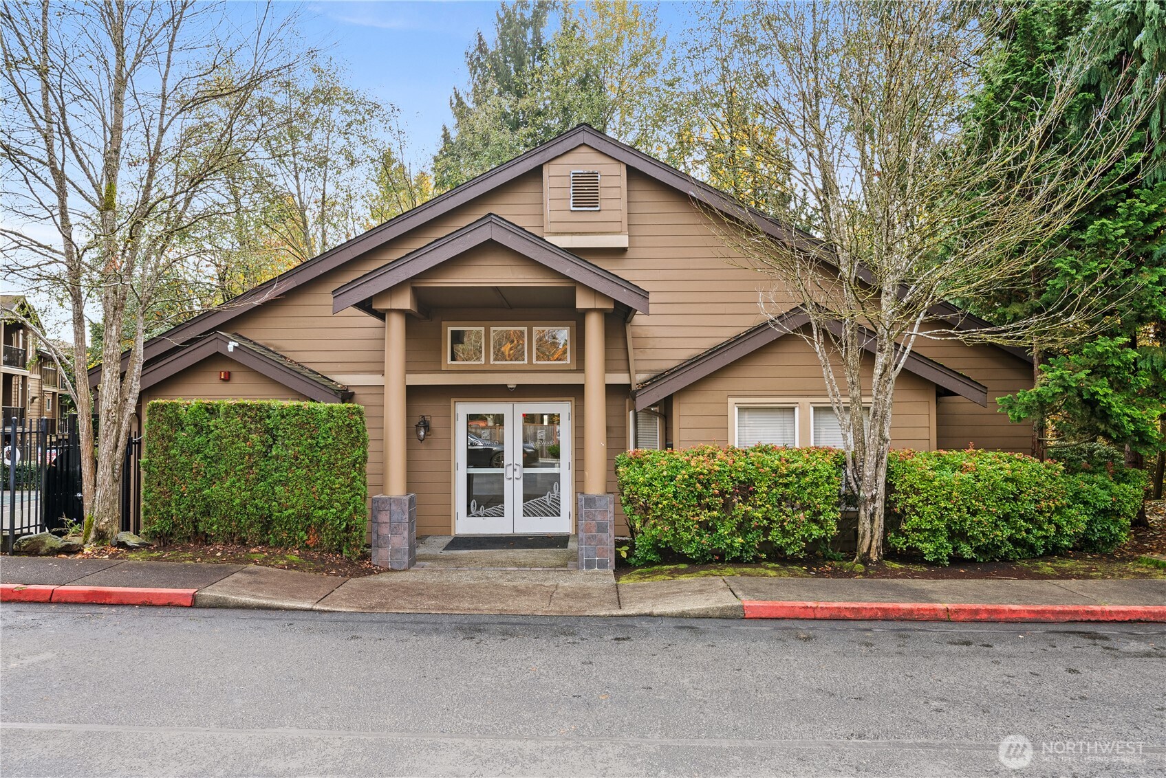 18930 Bothell Everett Highway, Unit G103 Bothell, WA 98012 - Photo 15 of 25 a front view of a house with a yard and garage