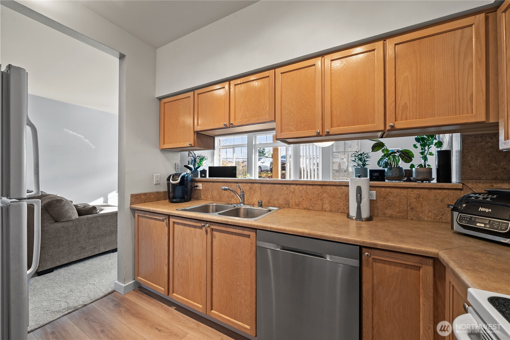 18930 Bothell Everett Highway, Unit G103 Bothell, WA 98012 - Photo 10 of 25 a kitchen with stainless steel appliances granite countertop a sink and a cabinets