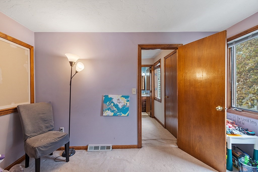 403 Cardinal Lane, Unit 403 Tyngsborough, MA 01879 - Photo 16 of 27 a view of hallway with furniture and a potted plant