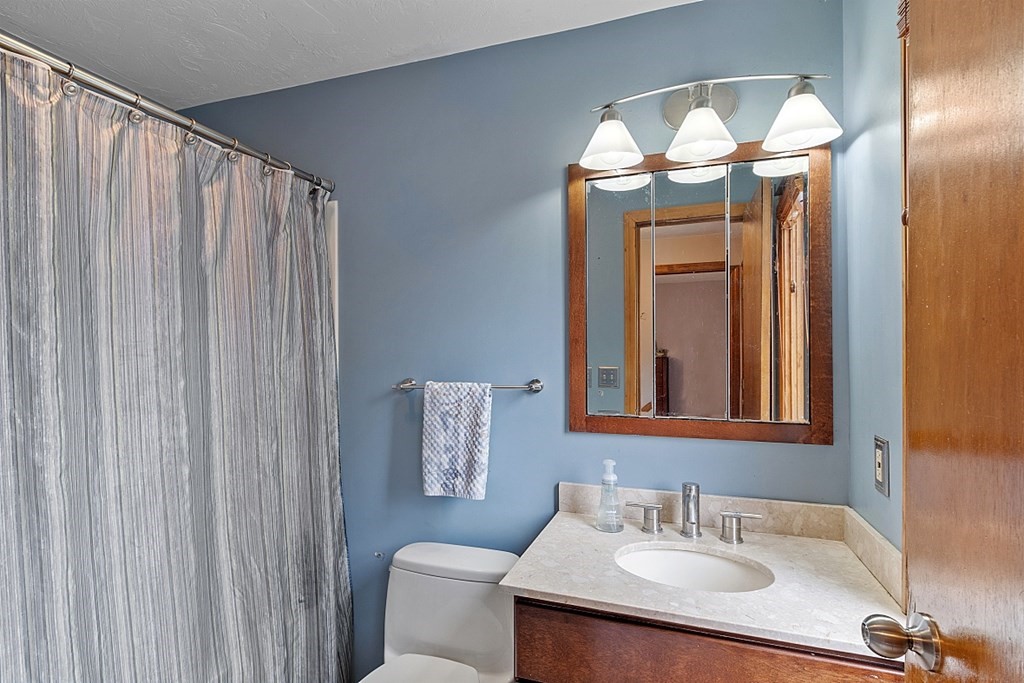 403 Cardinal Lane, Unit 403 Tyngsborough, MA 01879 - Photo 20 of 27 a bathroom with a sink and a mirror