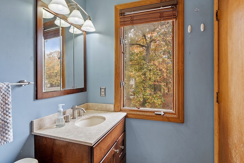 403 Cardinal Lane, Unit 403 Tyngsborough, MA 01879 - Photo 21 of 27 a bathroom with a sink vanity and a mirror
