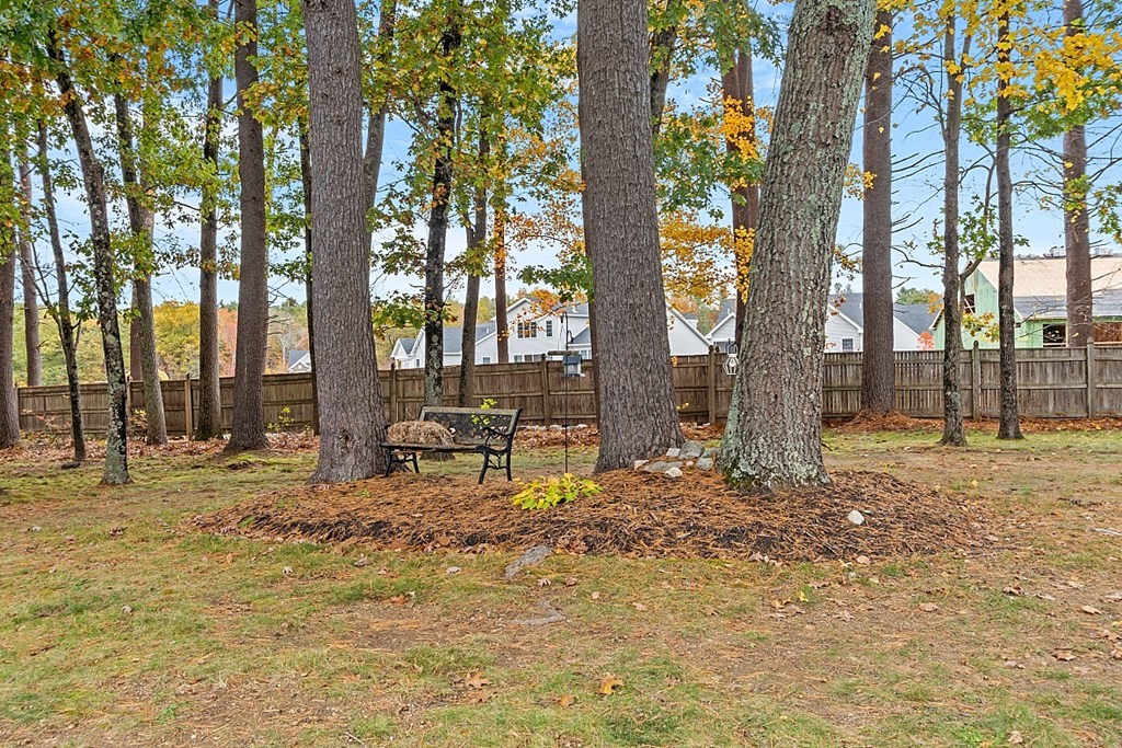 403 Cardinal Lane, Unit 403 Tyngsborough, MA 01879 - Photo 26 of 27 a backyard of a house with table and chairs