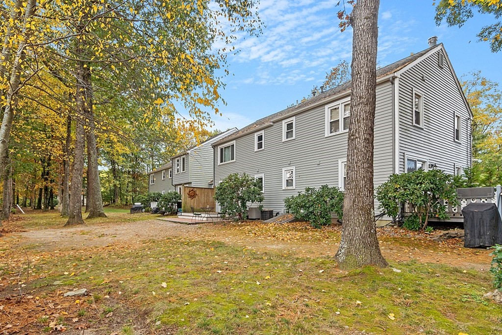 403 Cardinal Lane, Unit 403 Tyngsborough, MA 01879 - Photo 27 of 27 a front view of a house with a yard and garage