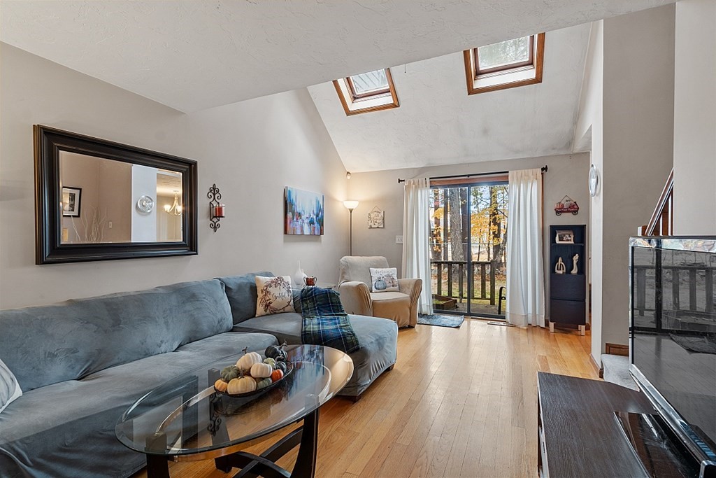 403 Cardinal Lane, Unit 403 Tyngsborough, MA 01879 - Photo 3 of 27 a living room with furniture and a wooden floor