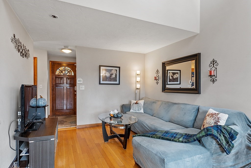 403 Cardinal Lane, Unit 403 Tyngsborough, MA 01879 - Photo 4 of 27 a living room with furniture and wooden floor