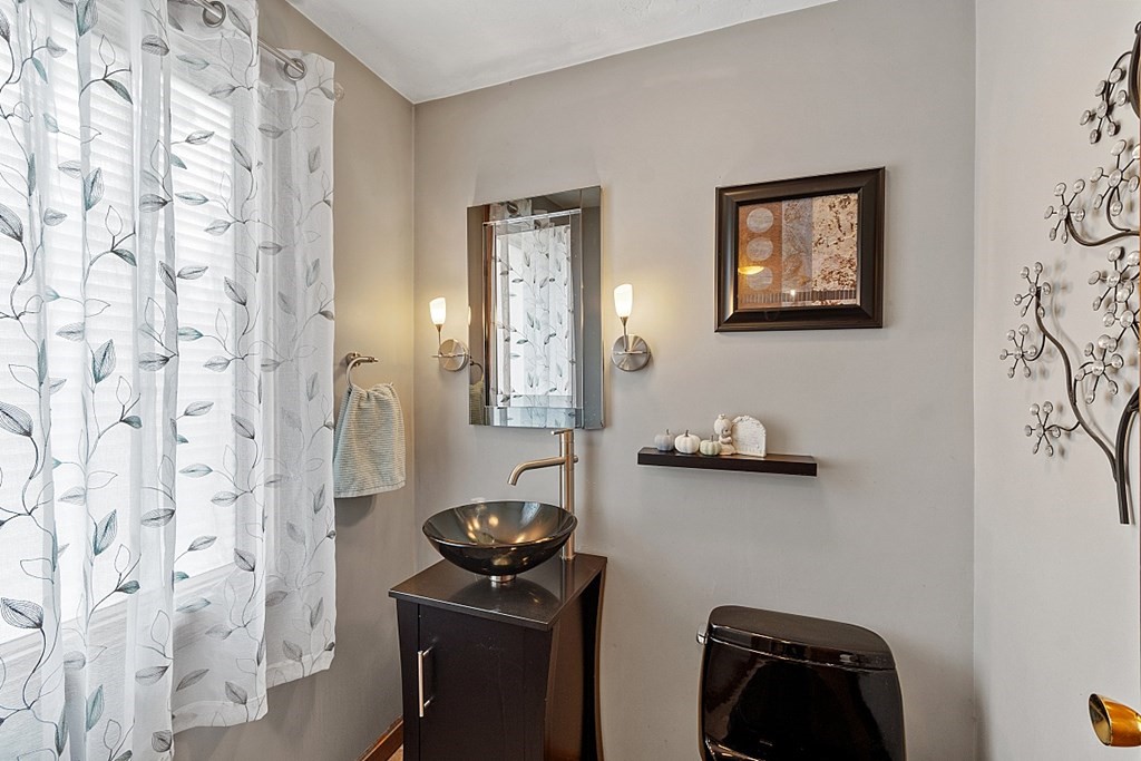 403 Cardinal Lane, Unit 403 Tyngsborough, MA 01879 - Photo 6 of 27 a bathroom with a sink a toilet a shower curtain and a mirror