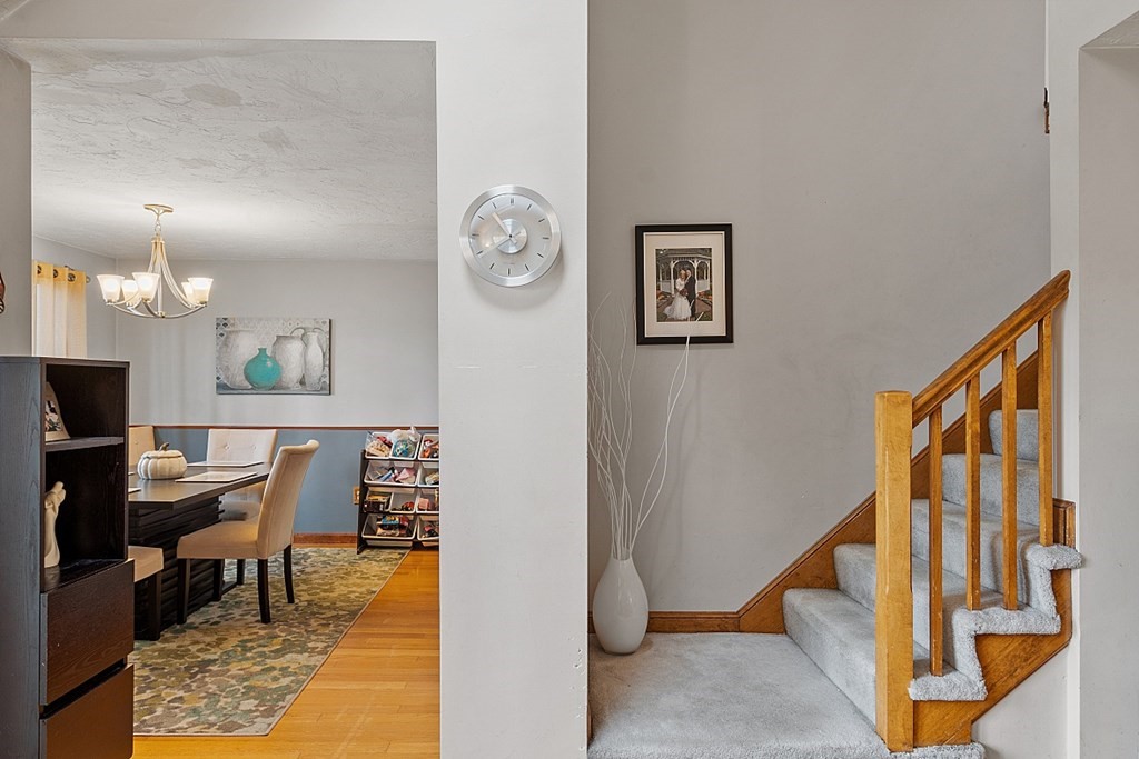 403 Cardinal Lane, Unit 403 Tyngsborough, MA 01879 - Photo 7 of 27 a view of a hallway with workspace and wooden floor
