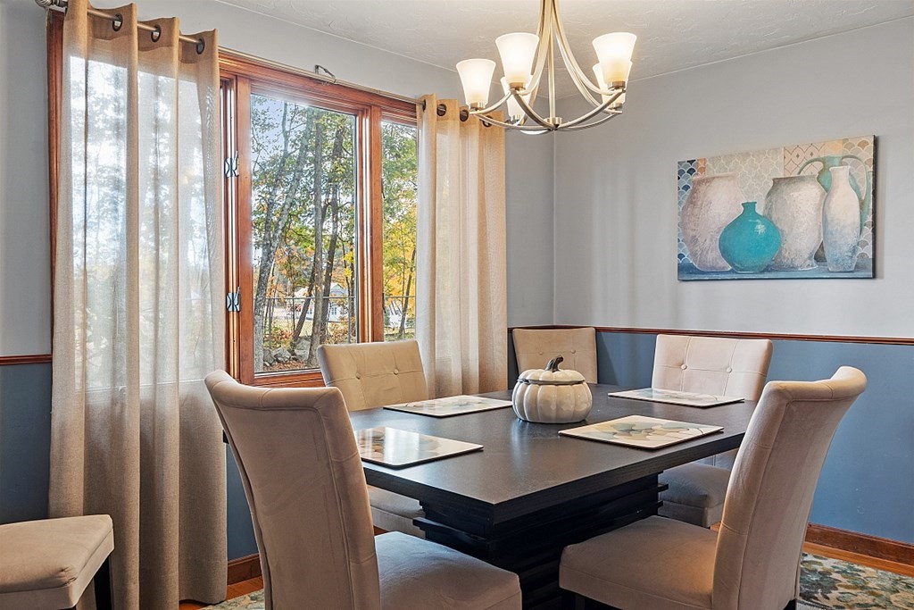 403 Cardinal Lane, Unit 403 Tyngsborough, MA 01879 - Photo 8 of 27 a view of a dining room with furniture window and outside view