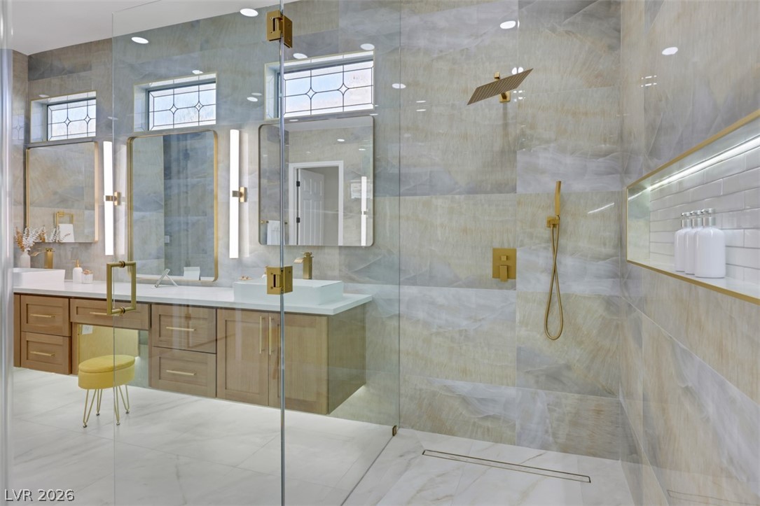 5015 Rivedro Street Las Vegas, NV 89135 - Photo 36 of 91 Indulge in a primary bathroom featuring a spacious glass shower and dual vanities, perfect for daily routines.