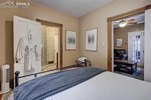 a bedroom with a bed and a mirror
