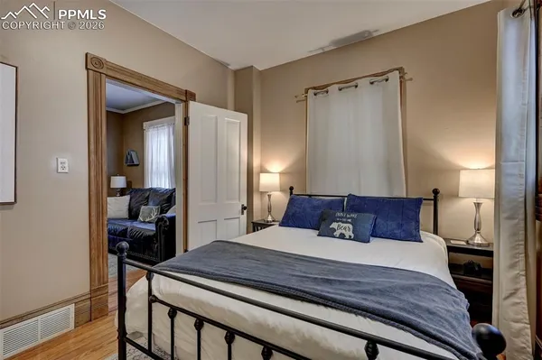 a bedroom with a bed and a mirror
