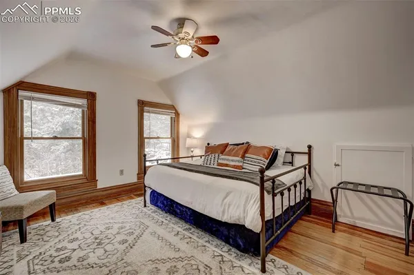 a bedroom with a bed lamp and a window