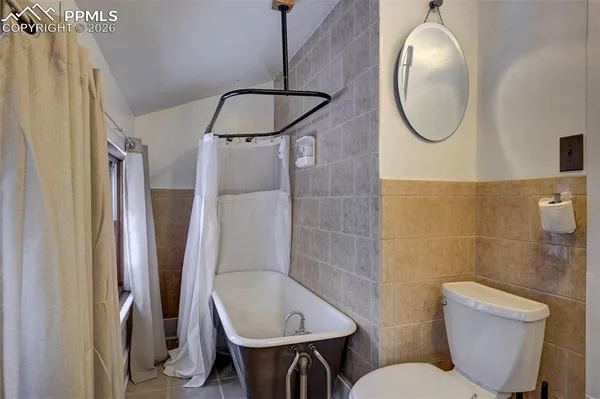 a bathroom with a toilet sink and shower