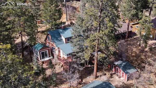 an aerial view of house with yard and trees
