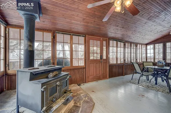 a kitchen that has a sink a table and chairs in it