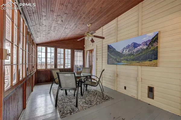 a dining room with furniture and wooden floor