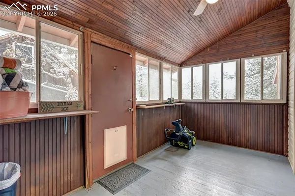 a view of a room with furniture wooden floor and windows