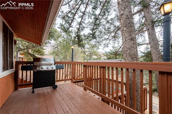 a view of a balcony with wooden floor and fence