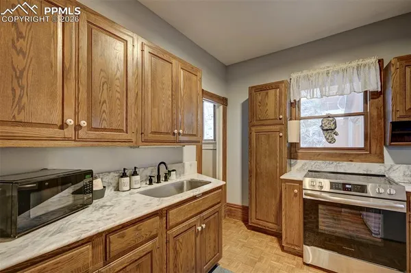 a kitchen with stainless steel appliances granite countertop a stove a refrigerator and a sink