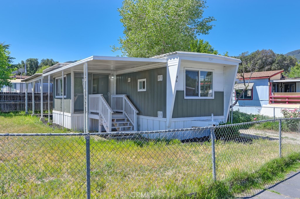26455 Paradise Valley Road, Unit 86 Warner Springs, CA 92086 - Photo 3 of 34 a view of a house with a small yard and deck