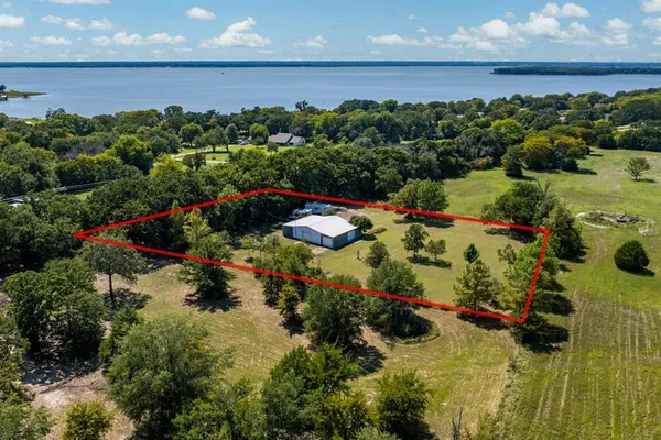 an aerial view of a house with a yard