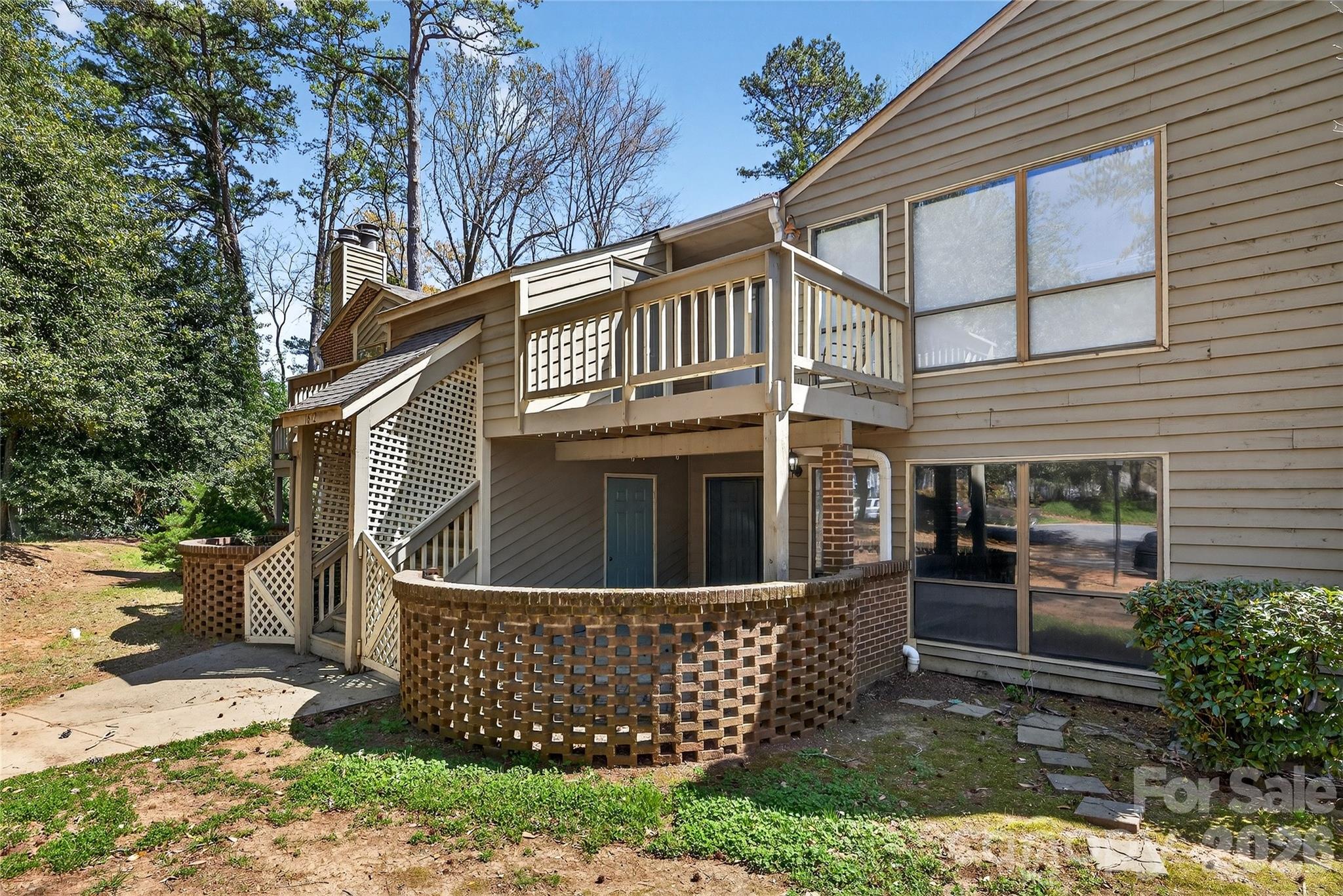 1612 Sharon Road West, Unit 67 Charlotte, NC 28210 - Photo 1 of 19 a view of a house with a yard