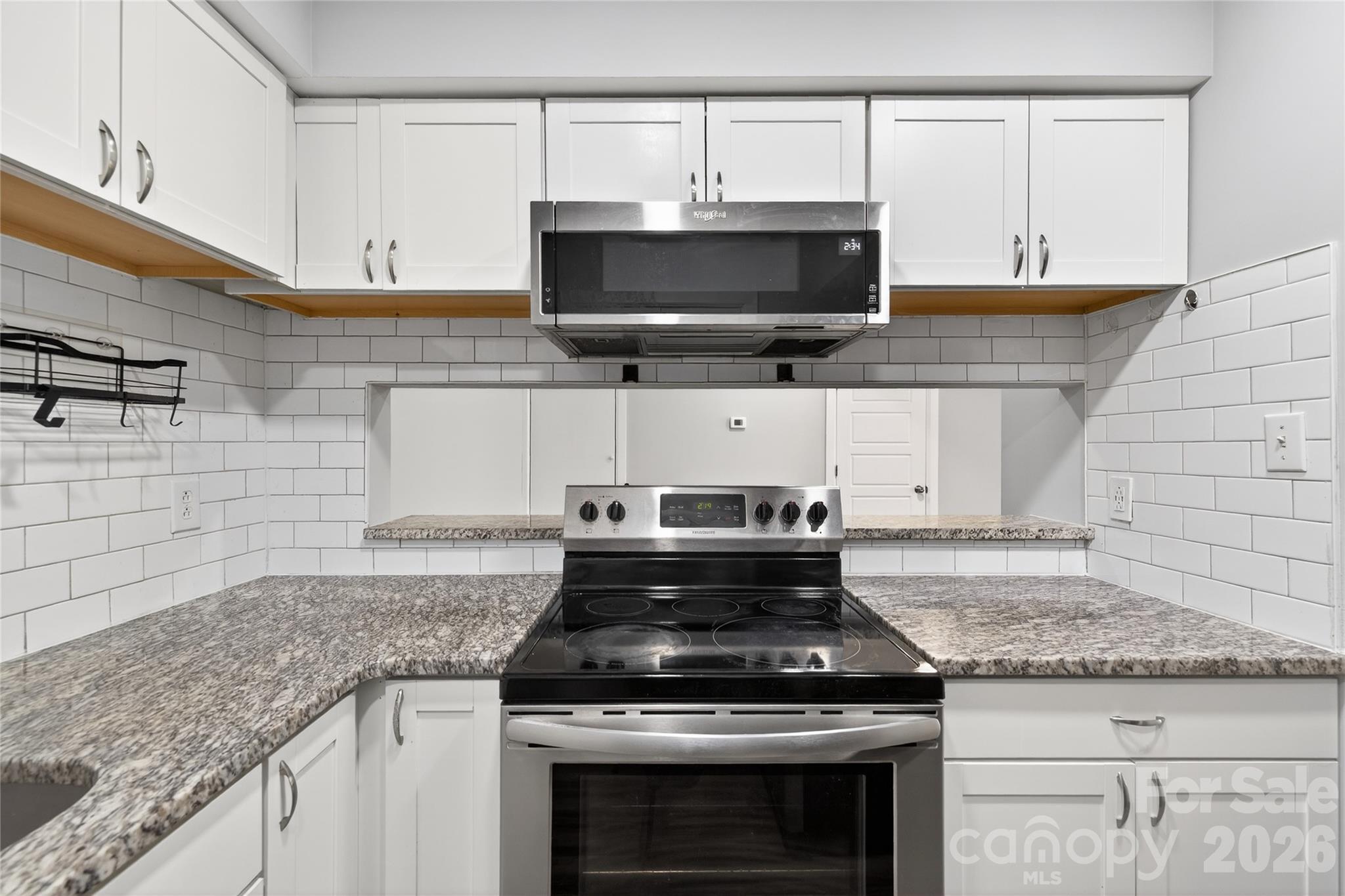 1612 Sharon Road West, Unit 67 Charlotte, NC 28210 - Photo 13 of 19 a stove top oven sitting inside of a kitchen