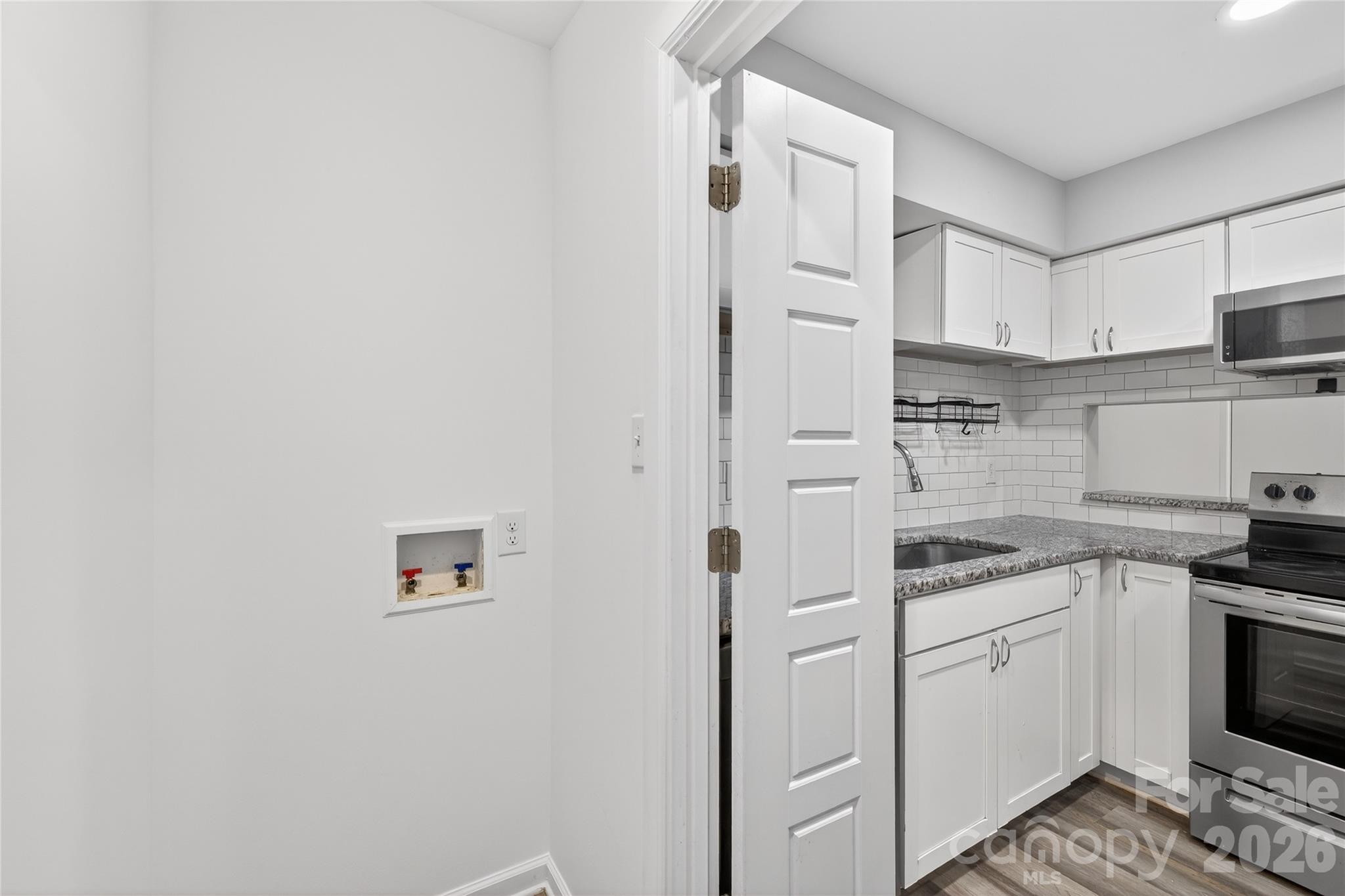 1612 Sharon Road West, Unit 67 Charlotte, NC 28210 - Photo 15 of 19 a kitchen with cabinets and appliances
