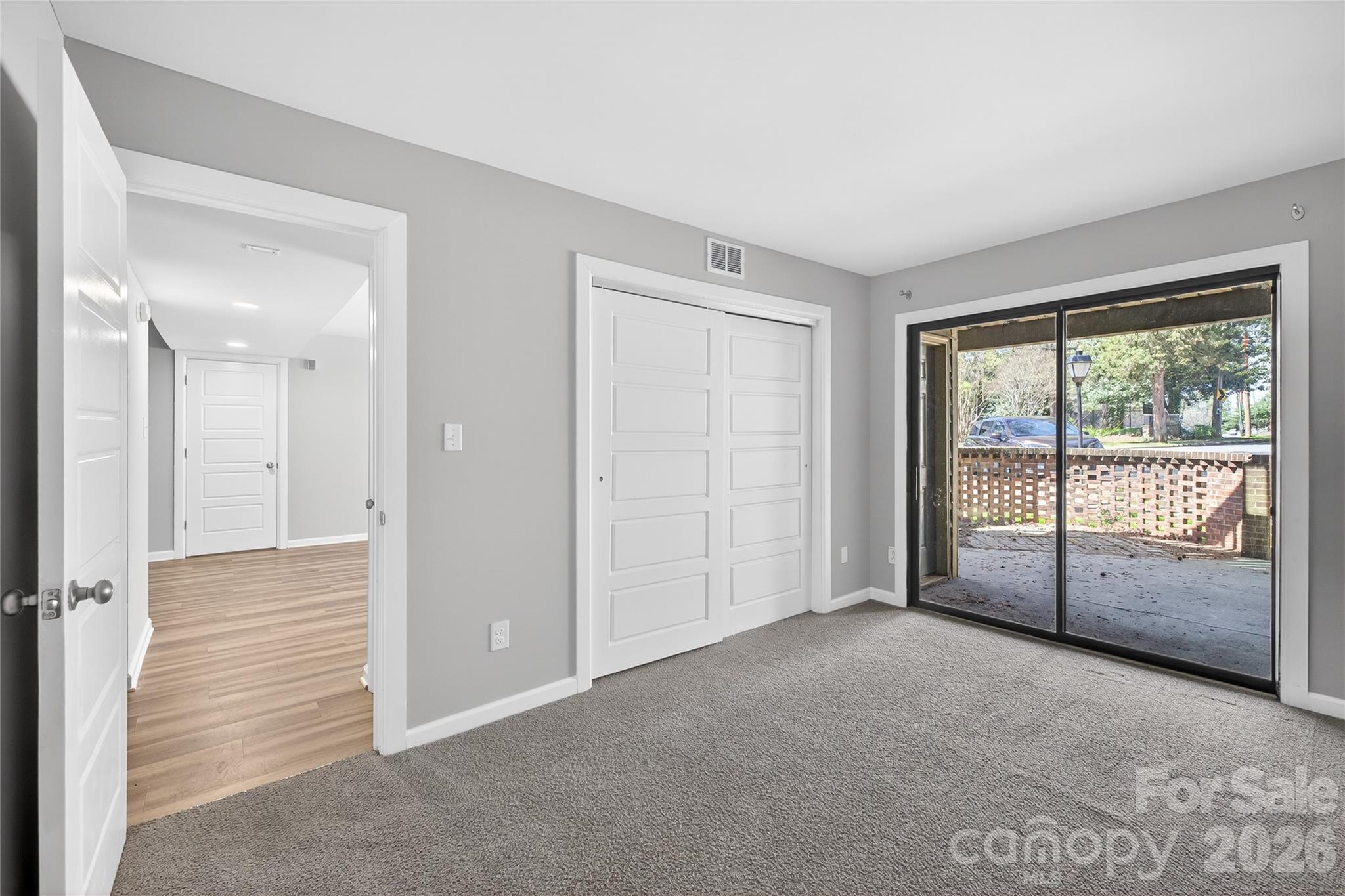 1612 Sharon Road West, Unit 67 Charlotte, NC 28210 - Photo 16 of 19 a view of an empty room with glass door